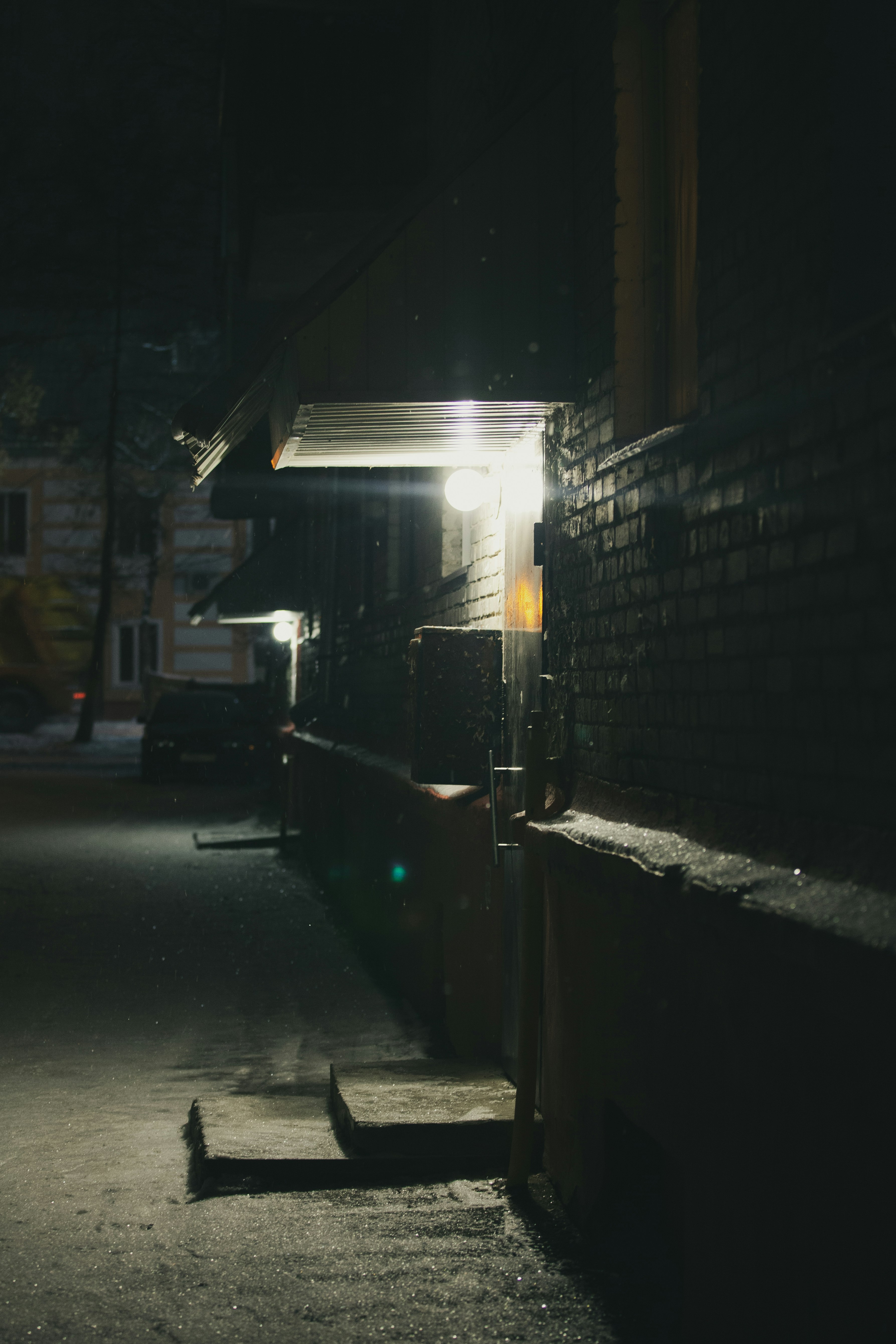 black car parked beside building during night time